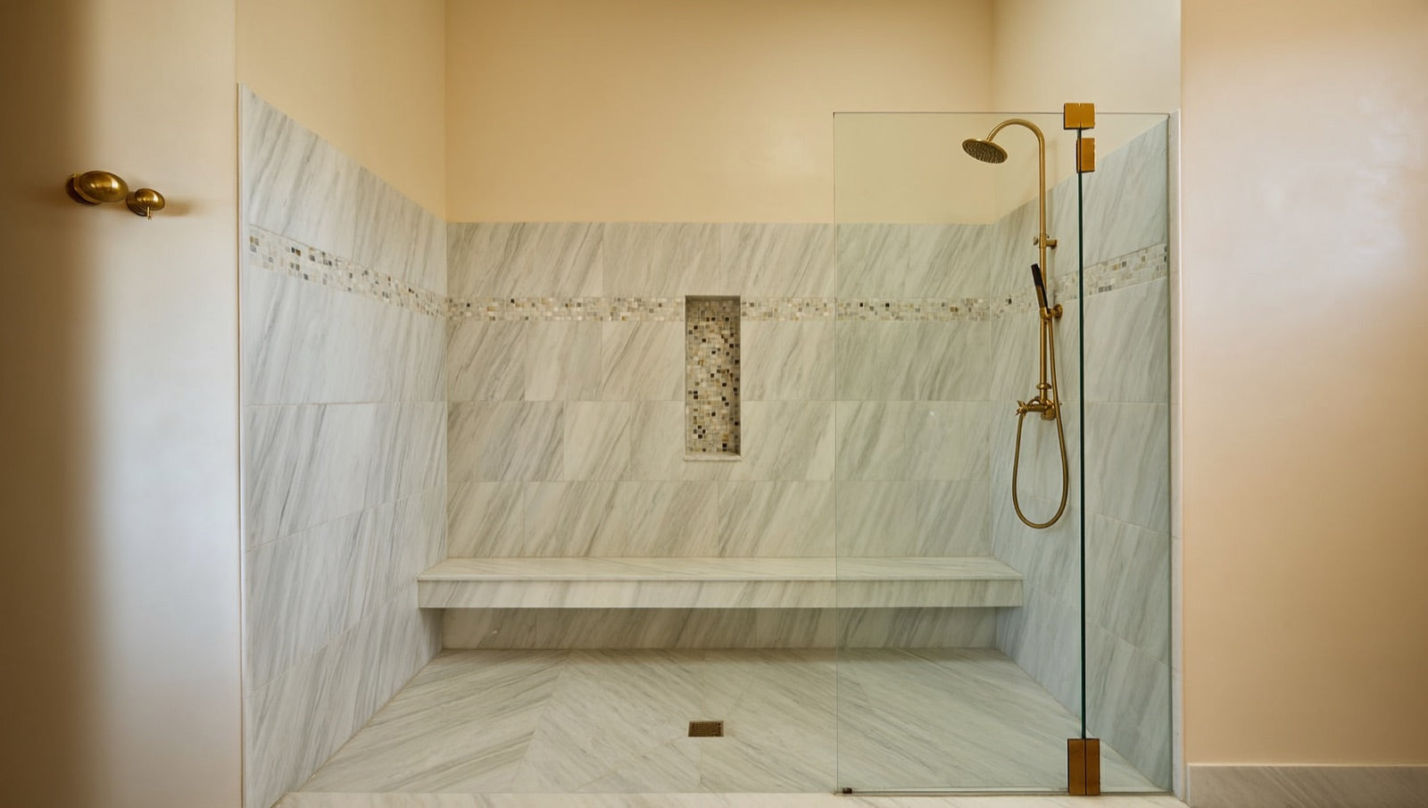 Curbless walk-in shower with bench, niche and glass panel replacing an old bathtub alcove
