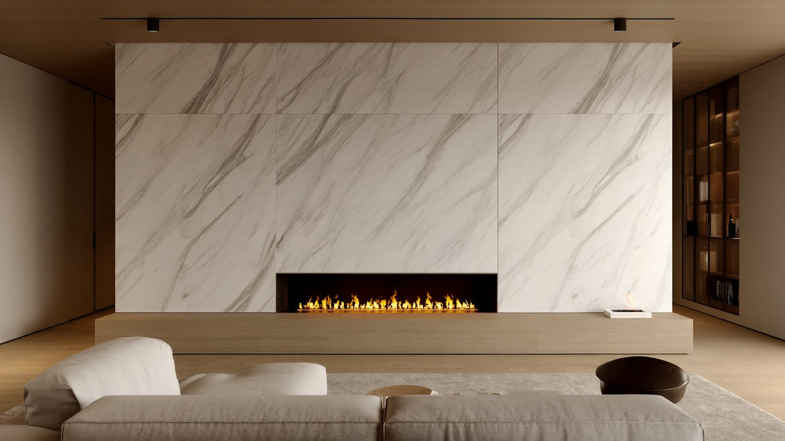 A modern living room fireplace with a floor-to-ceiling marble-look porcelain slab surround and a flush stone hearth in the ANVE style, lit by a warm firelight glow.