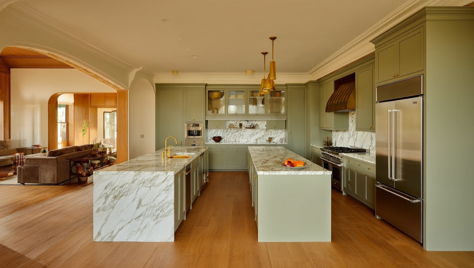 Open-concept kitchen layout with a large island and clear work zones between range, sink and refrigerator