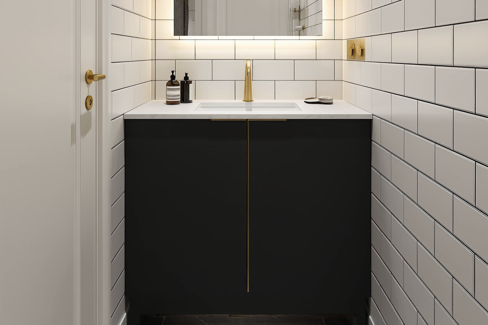 Compact matte black bathroom vanity in a small modern bathroom with white tile walls, LED mirror, and brushed gold hardw