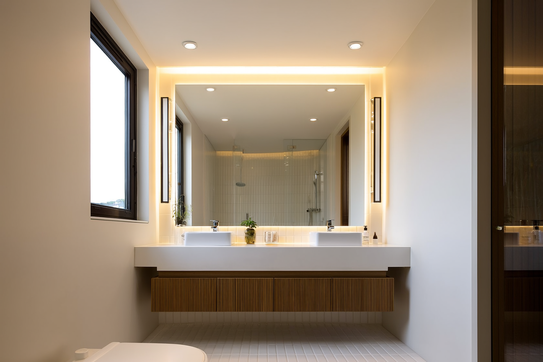 Contemporary bathroom with layered lighting including vanity bar lights at mirror level and warm ambient overhead fixtur