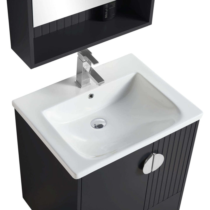 A modern white rectangular sink with a chrome faucet sits atop the Venezian 24 inch Bathroom Vanity With Sink, featuring a black cabinet and round handle. Above, a mirror cabinet with an open shelf is mounted.