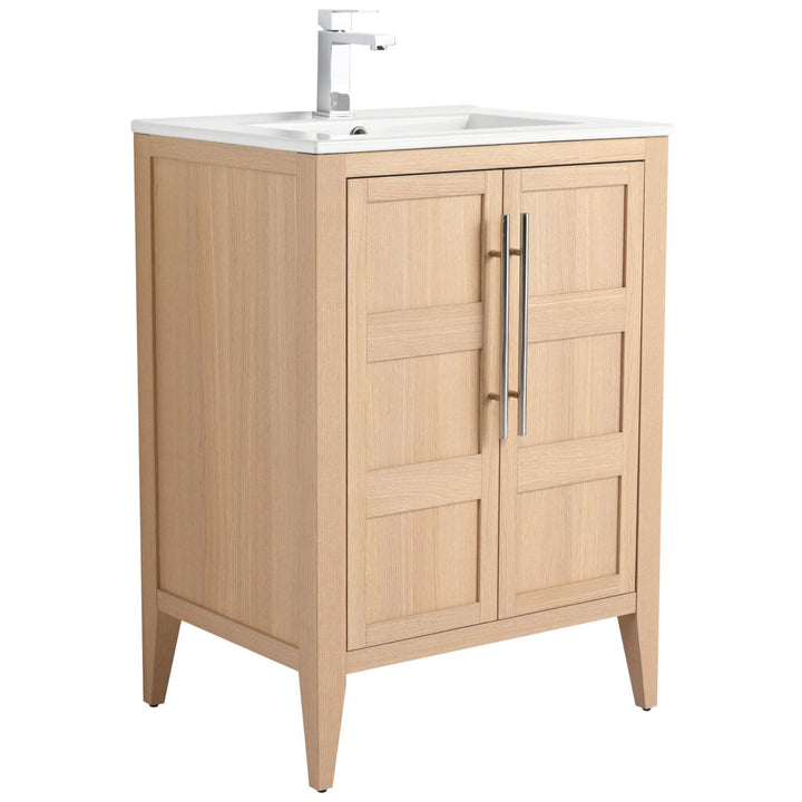 The Leafside 24 Inch Bathroom Vanity With Sink features a light wood finish, shaker-style doors, metal handles, and a white sink with a modern faucet. It elegantly stands on four tapered legs, blending style and functionality.