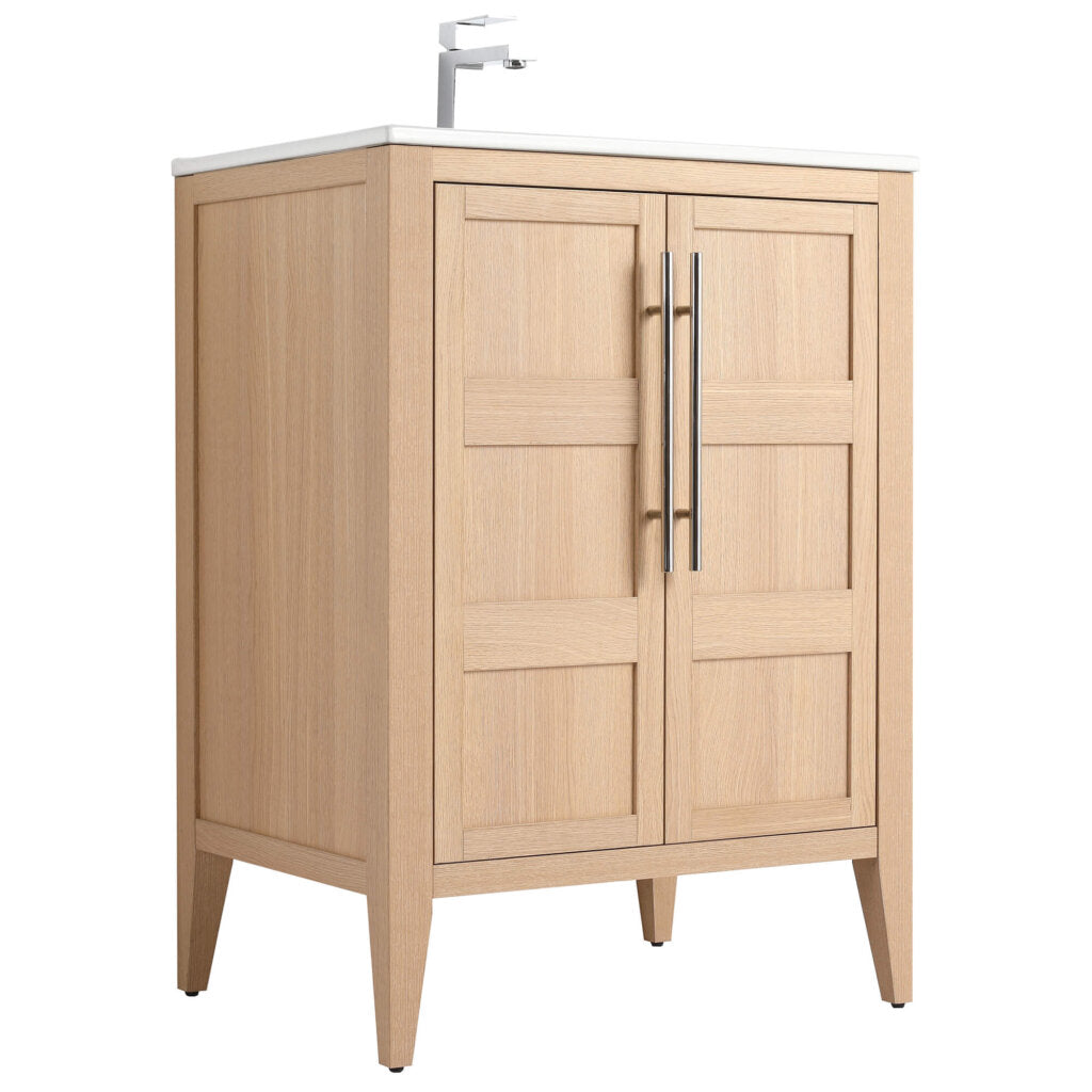 The Leafside 24 Inch Bathroom Vanity With Sink features an oak-colored finish, white countertop, sleek modern faucet, two paneled doors with vertical metal handles, and stands on four tapered legs, creating a simple yet elegant design.