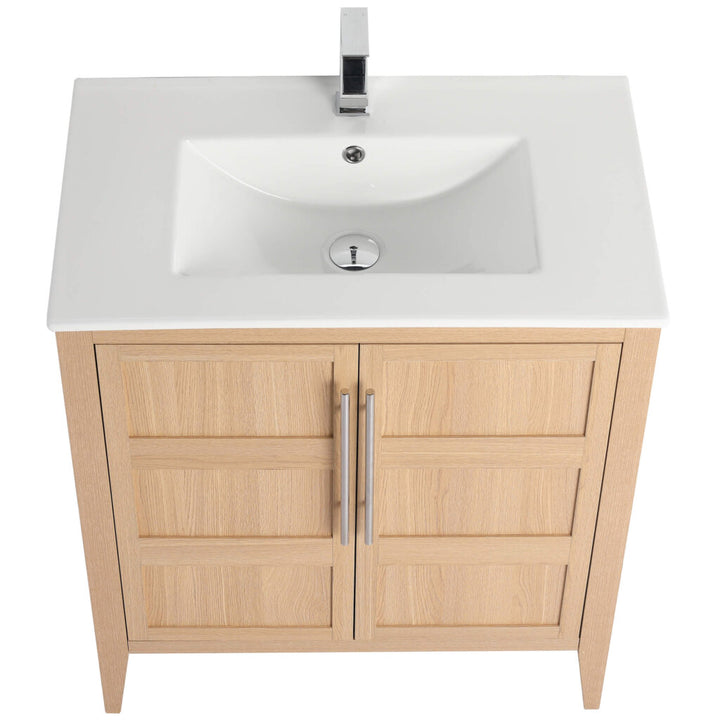 The Leafside 30 Inch Bathroom Vanity With Sink showcases its elegant design with a top view of a white ceramic sink, silver faucet, two paneled doors with vertical silver handles, and a centered faucet above the circular drain.