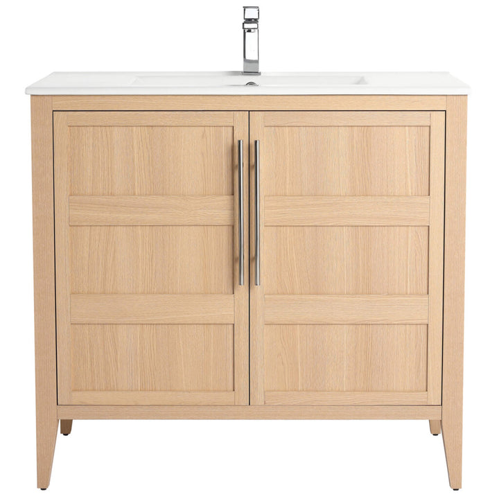 The Leafside 36 Inch Bathroom Vanity With Sink features a natural finish, double paneled doors, sleek vertical handles, a pristine white countertop, and a modern silver faucet, blending style and function for your bathroom oasis.