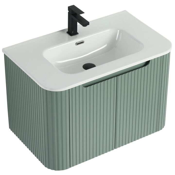 The Caskvalley 30 Wall Mounted Bathroom Vanity boasts a modern design, with a smooth white basin, muted green vertical paneling, and a sleek black faucet above the refined sink for added sophistication.