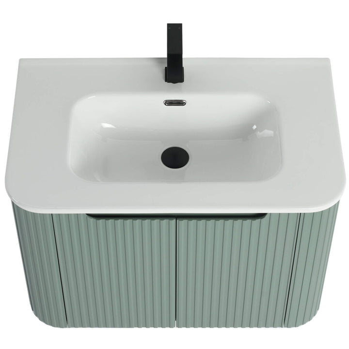 The Caskvalley 30 Inch Wall Mounted Bathroom Vanity With Sink features a modern white ceramic basin, black faucet, and green ribbed-texture cabinet. It includes an overflow hole, centered drain, and two-door storage for a chic bathroom setup.