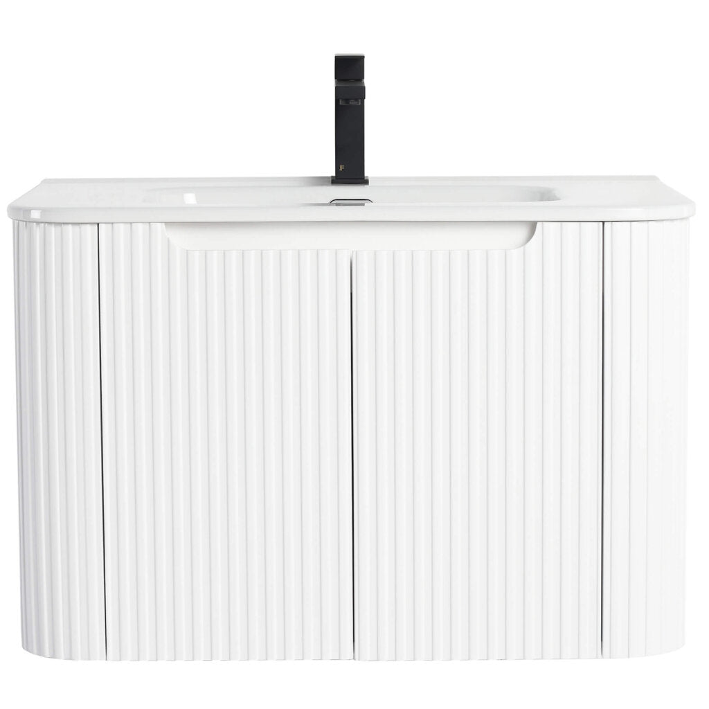 The Caskvalley 30 Inch Wall Mounted Bathroom Vanity With Sink offers a sleek design with two vertical paneled cabinet doors, a smooth countertop, and a built-in sink. This white vanity is accented by a striking black faucet.
