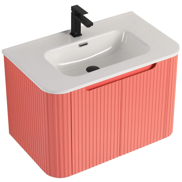 The Caskvalley 30 Wall Mounted Bathroom Vanity With Sink boasts a modern rectangular basin with a sleek black faucet, adorned in textured vertical pink panels and includes an overflow opening for added elegance.