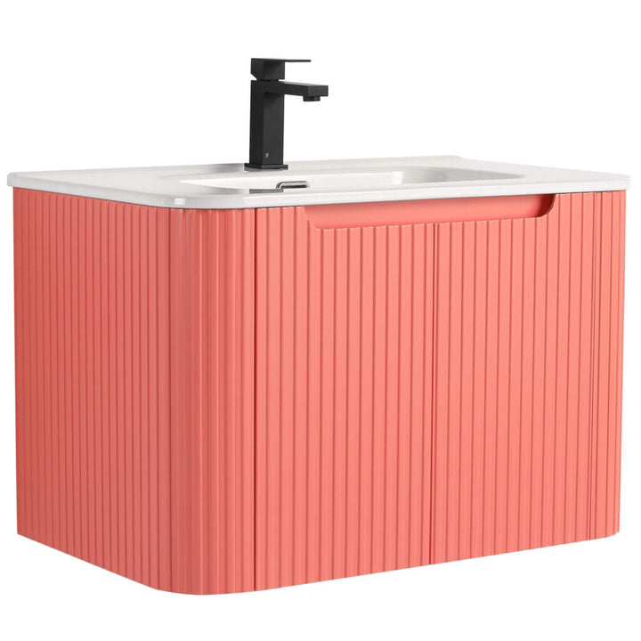 The Caskvalley 30 Inch Wall Mounted Bathroom Vanity features a modern design with a textured coral cabinet, sleek white countertop, black rectangular faucet, integrated basin, and ribbed cabinet detailing for added style.