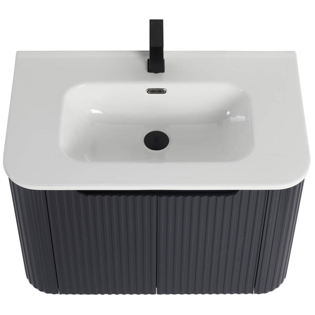 The Caskvalley 30 Inch Wall Mounted Bathroom Vanity With Sink features a modern white rectangular basin and sleek black faucet on a dark, textured cabinet with vertical lines. The central drain enhances its minimalist and stylish design.