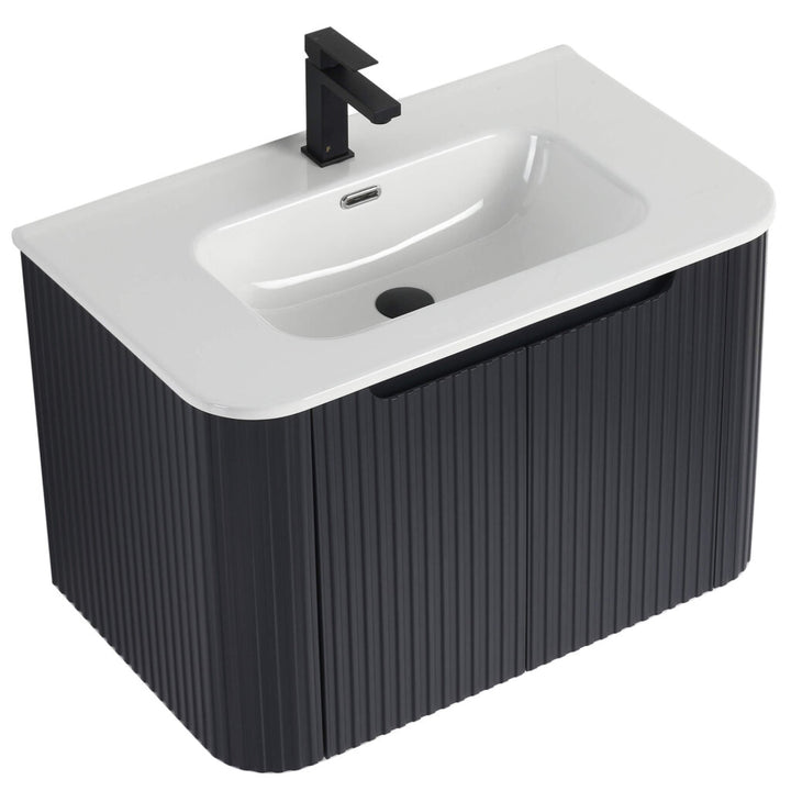 The Caskvalley 30 Inch Wall Mounted Bathroom Vanity With Sink offers a sleek modern look with its white basin, ribbed black cabinet, matte black faucet, and built-in overflow—perfectly blending style and function.