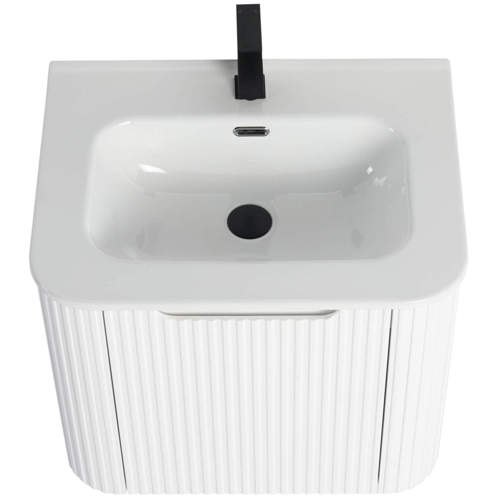 The Caskvalley 24 Inch Wall Mounted Bathroom Vanity features a ribbed cabinet with a white rectangular basin, a sleek black faucet, central drain, and overflow hole, offering a modern design that contrasts beautifully with the smooth sink surface.