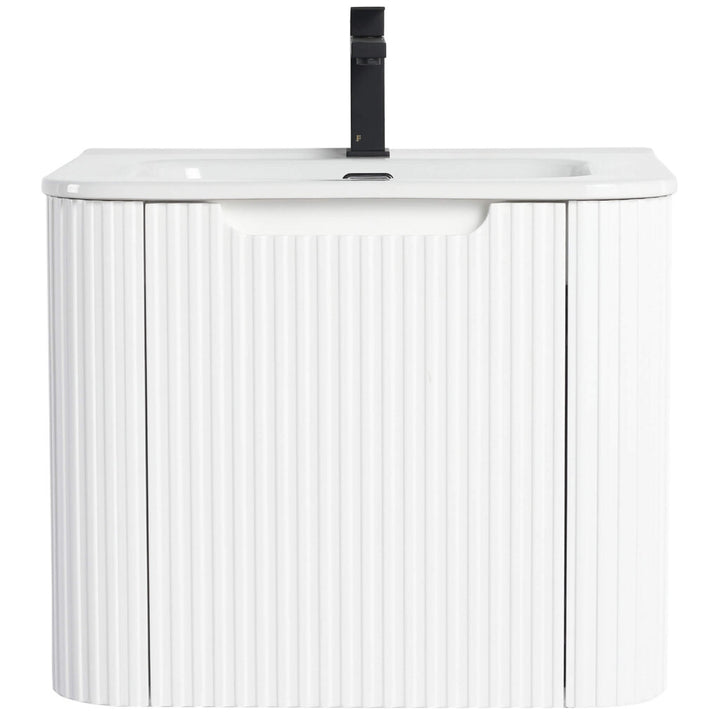 The Caskvalley 24 Inch Wall Mounted Bathroom Vanity With Sink boasts a minimalist design with a white ribbed texture. It includes a rectangular basin, integrated black faucet, and two storage doors below for a modern, sleek bathroom look.
