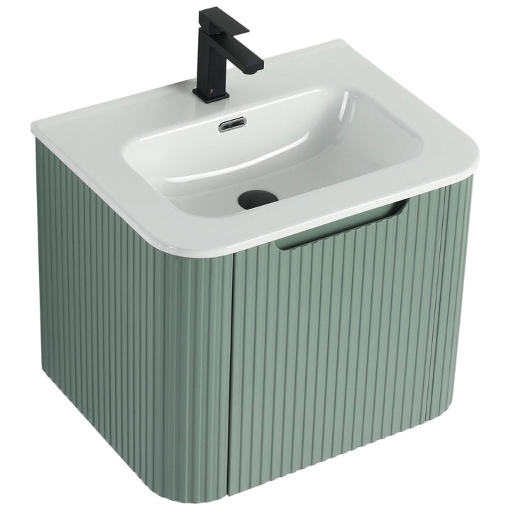 The Caskvalley 24 Inch Wall Mounted Bathroom Vanity With Sink boasts a modern design with a sleek white basin, matte black faucet, and a muted green pedestal featuring vertical grooves for a contemporary touch.