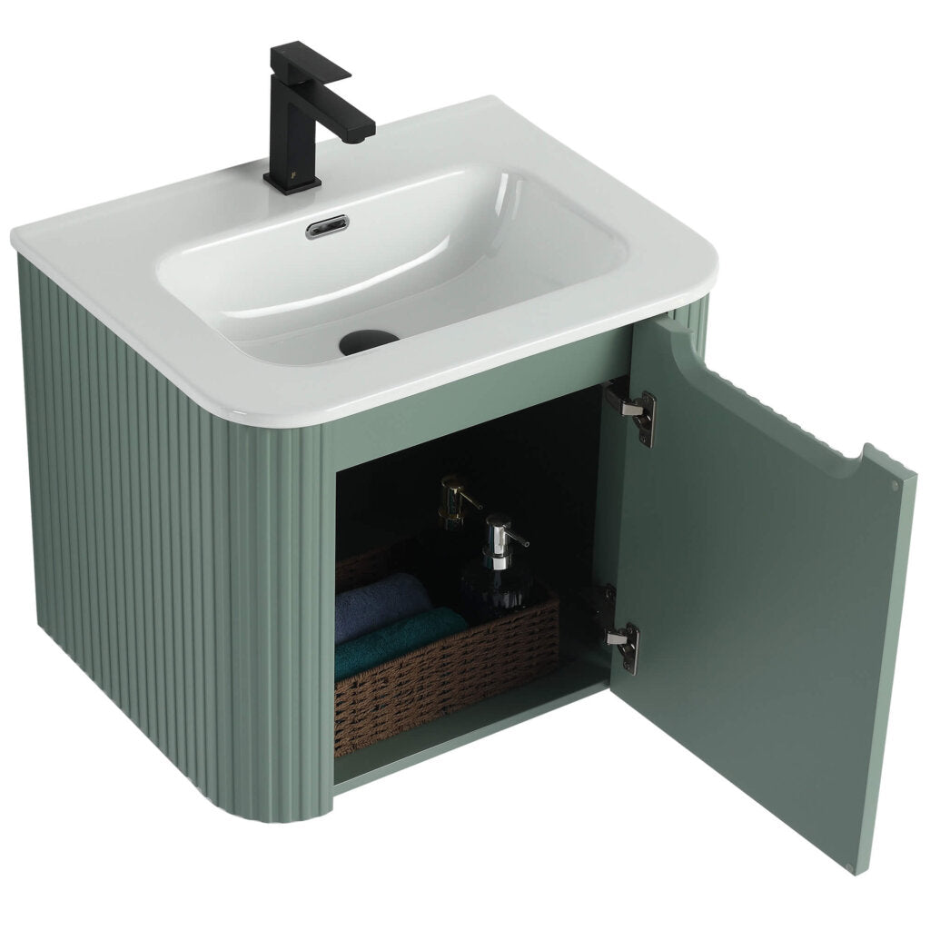Unveil the Caskvalley 24 Inch Wall Mounted Bathroom Vanity With Sink. It features a modern white basin, sleek black faucet, and a green ridged wooden cabinet with an open door, showcasing a wicker basket containing toiletries and folded towels.