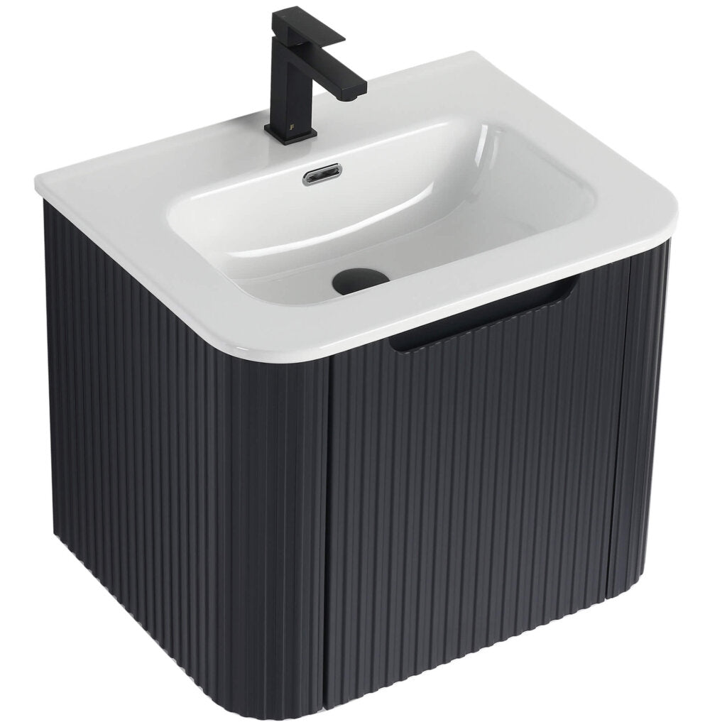 The Caskvalley 24 Wall Mounted Vanity showcases a modern design, featuring a sleek black ribbed cabinet and white basin. It includes a contemporary black faucet at the back, enhancing its minimalist and stylish appeal.
