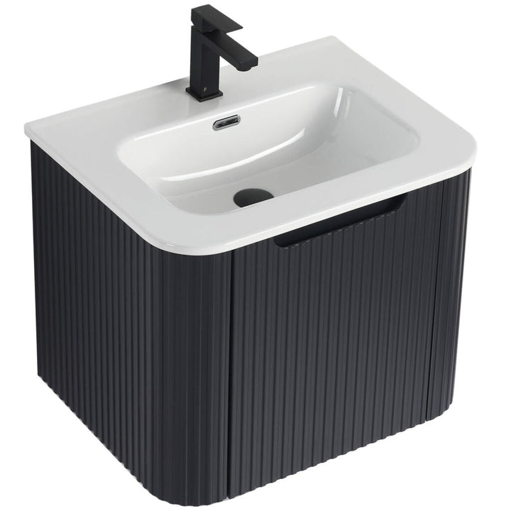 The Caskvalley 24 Wall Mounted Vanity showcases a modern design, featuring a sleek black ribbed cabinet and white basin. It includes a contemporary black faucet at the back, enhancing its minimalist and stylish appeal.