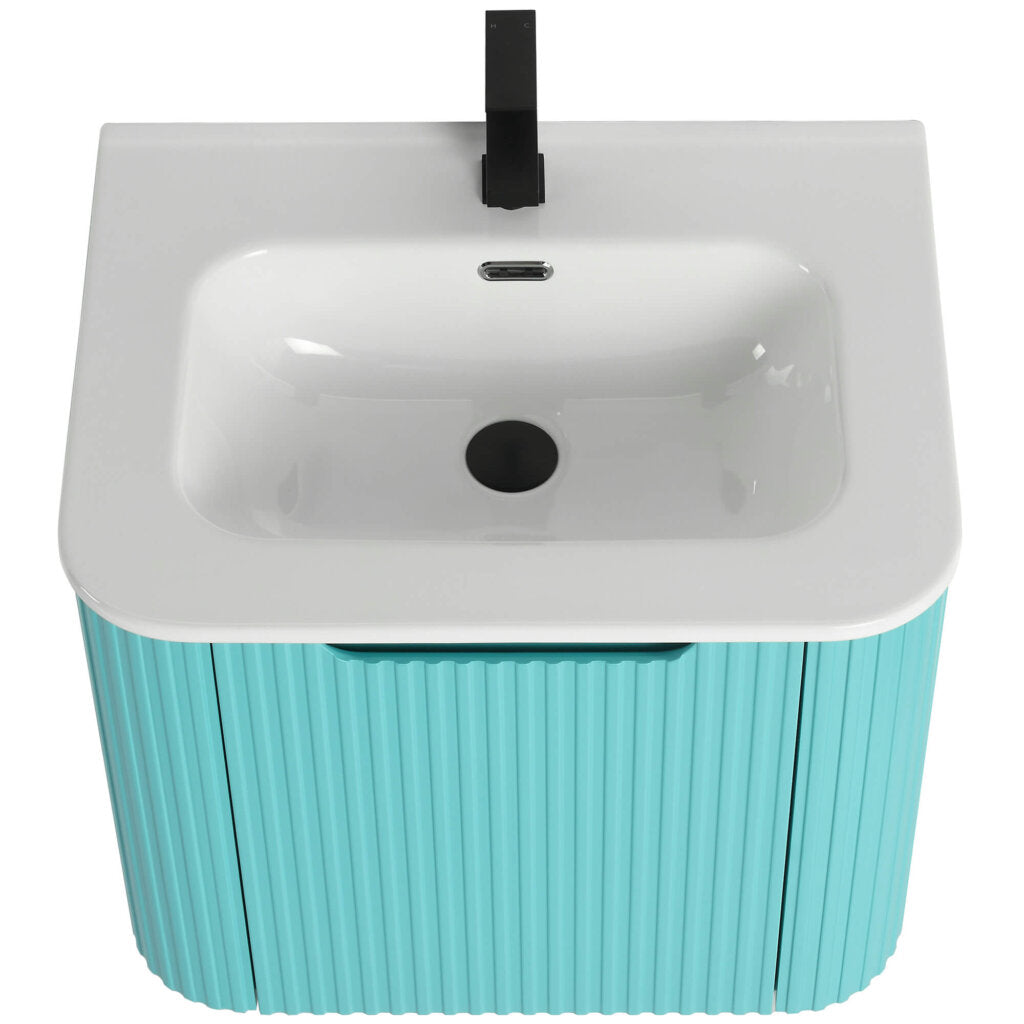 The Caskvalley 24 Inch Wall Mounted Bathroom Vanity With Sink includes a stylish white basin, a black faucet, and a turquoise cabinet with vertical ridges for added texture, creating a perfect fusion of style and functionality in any bathroom.