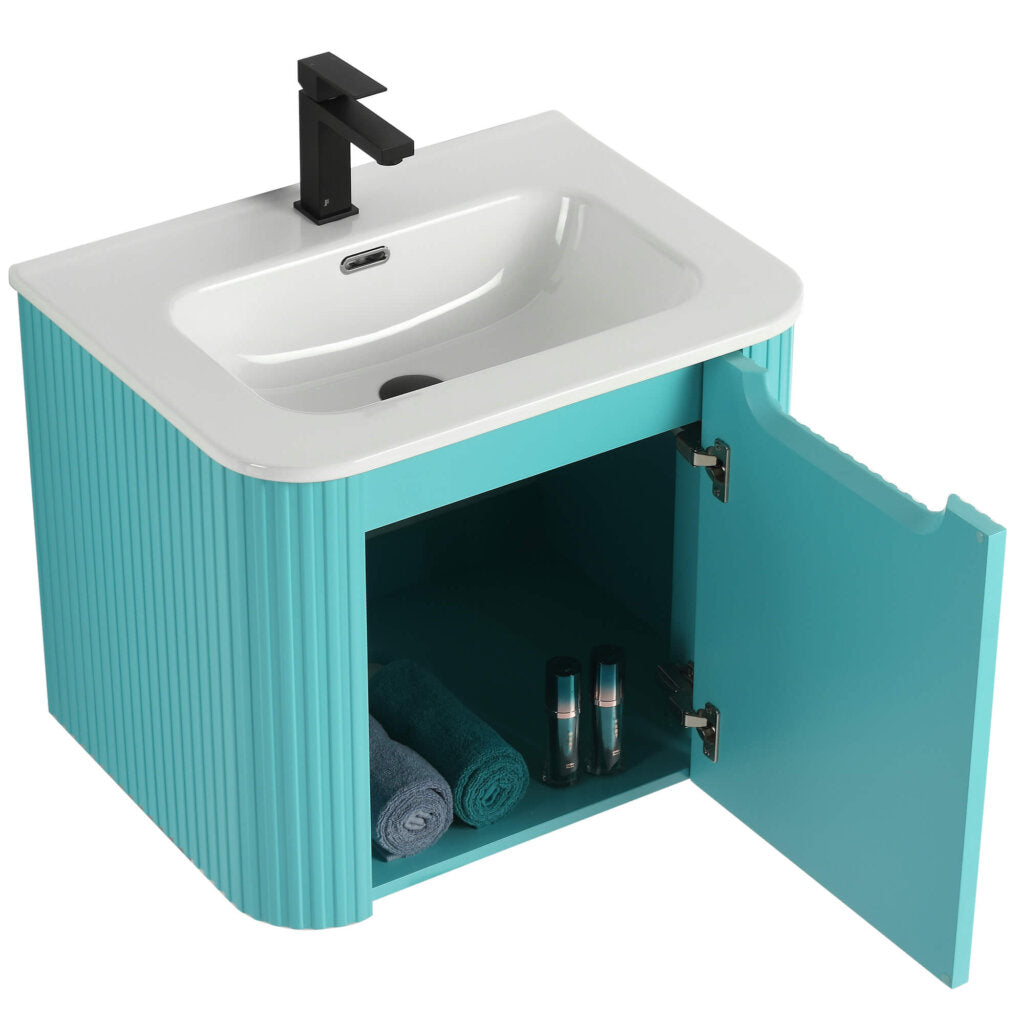The Caskvalley 24 Inch Wall Mounted Bathroom Vanity With Sink features a white rectangular sink and sleek black faucet. Its textured teal cabinet opens to reveal two rolled blue towels and two bottles, offering a stylish yet practical solution.