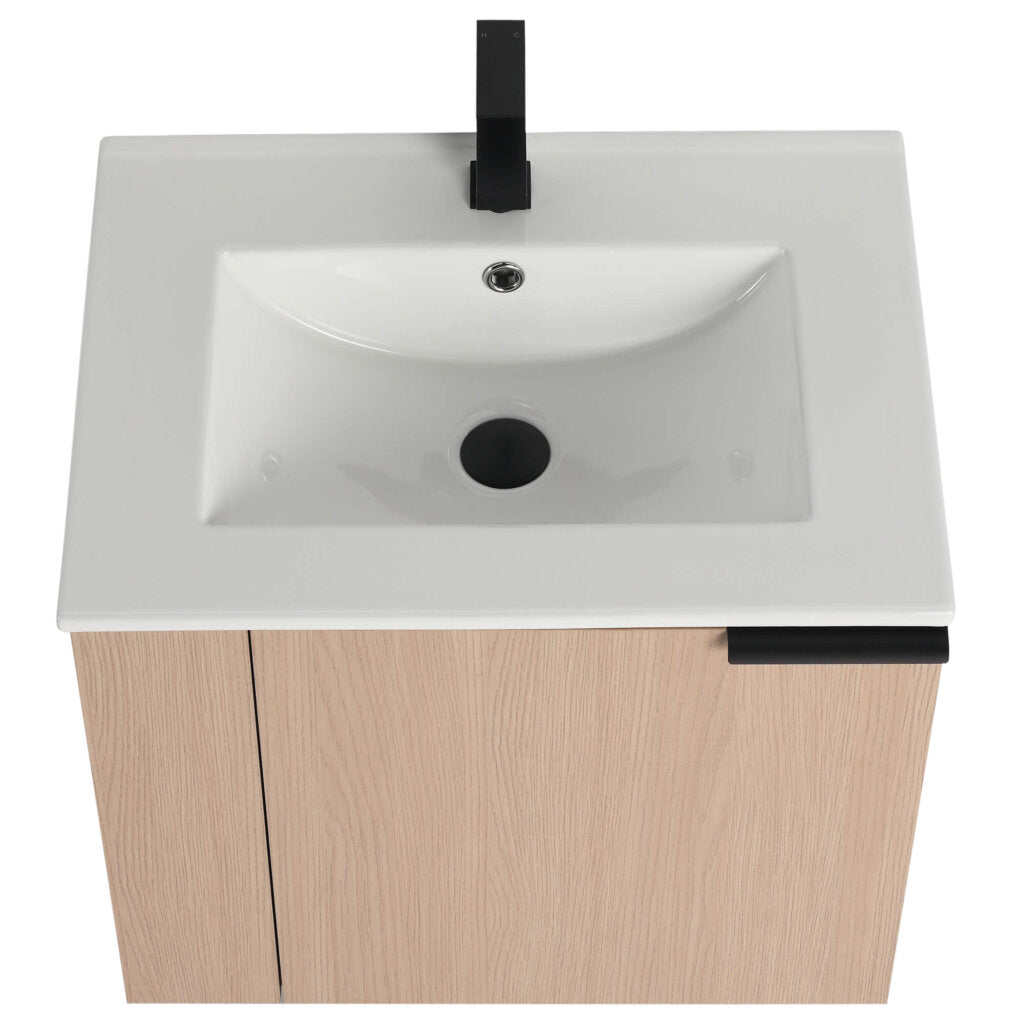 A top-down view of the Elmridge 24 Inch Wall Mounted Bathroom Vanity With Sink shows a white rectangular basin in a light wood frame, featuring a sleek black faucet and central drain, with a matching black handle elegantly placed on the side.