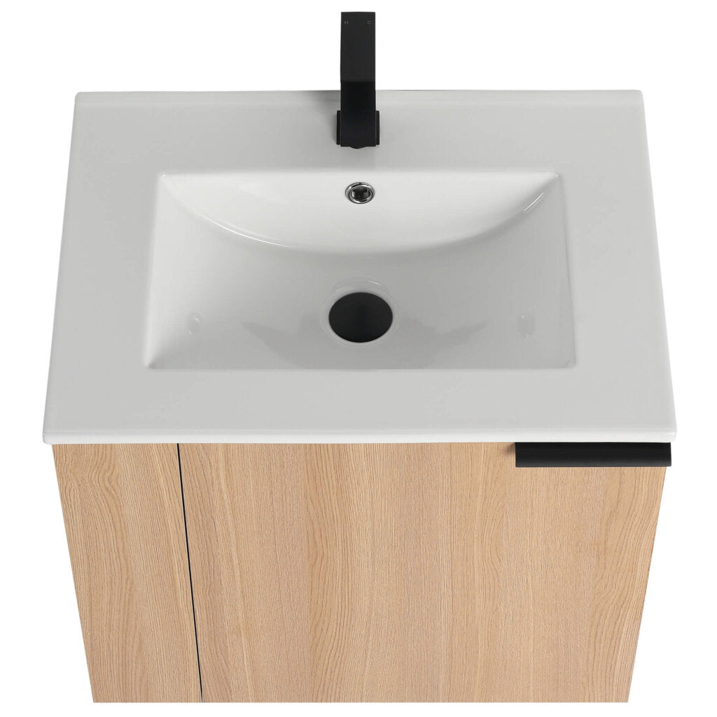 An aerial view highlights the Elmridge 24 Wall Mounted Vanity with Sink, featuring a sleek white rectangular sink and black faucet on a light wood cabinet with clean lines and hidden handles for a minimalist look.