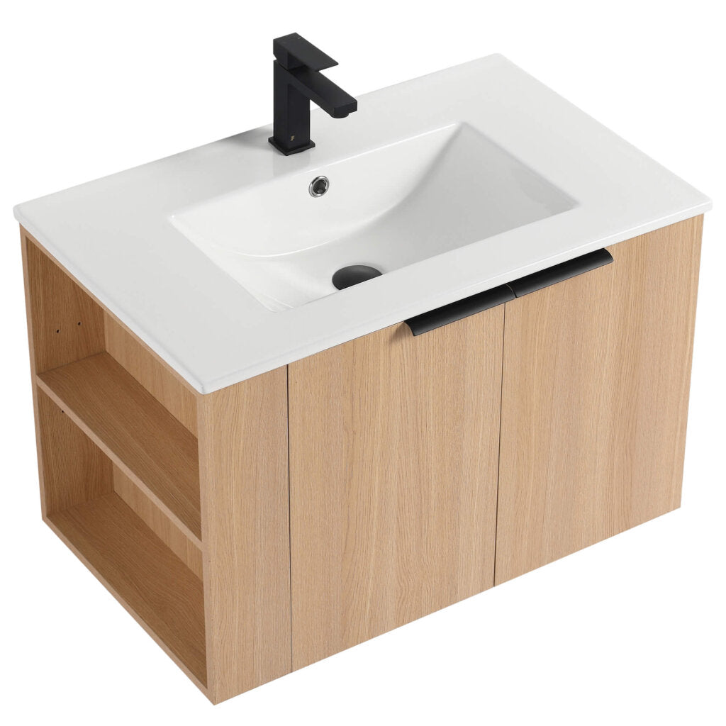 The Elmridge 30 Inch Wall Mounted Bathroom Vanity With Sink includes a white rectangular sink on a light wood cabinet with side open shelving. It has a sleek black faucet and matching cabinet door handles, combining modern style with functionality.