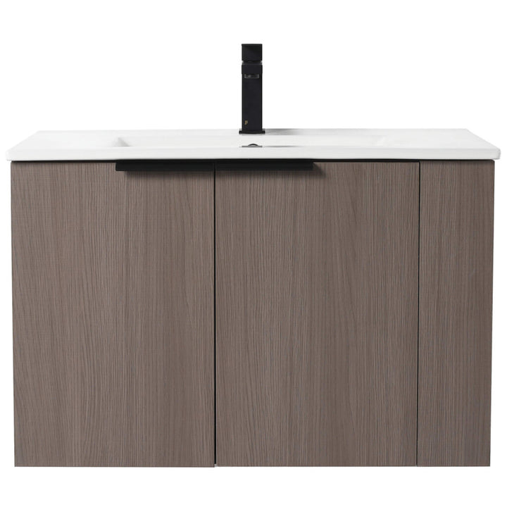 The Elmridge 30 Inch Wall Mounted Bathroom Vanity With Sink boasts a white countertop with an integrated sink, two light brown wooden cabinet doors, and is accented by a central matte black faucet.