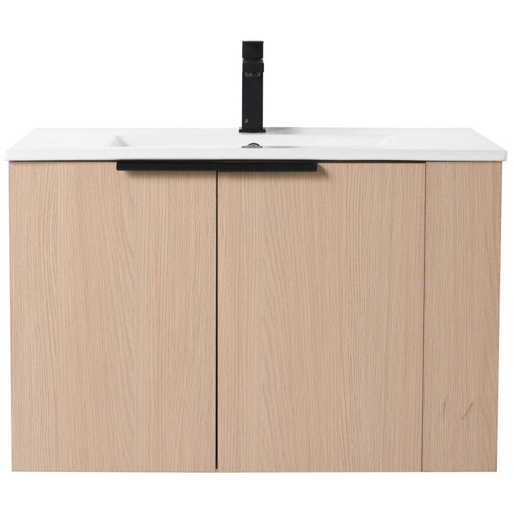 The Elmridge 30 Inch Wall Mounted Bathroom Vanity With Sink features a modern light wood design with a white countertop and sleek black accents, including a faucet and central cabinet handle, perfect for elevating any minimalist bathroom.