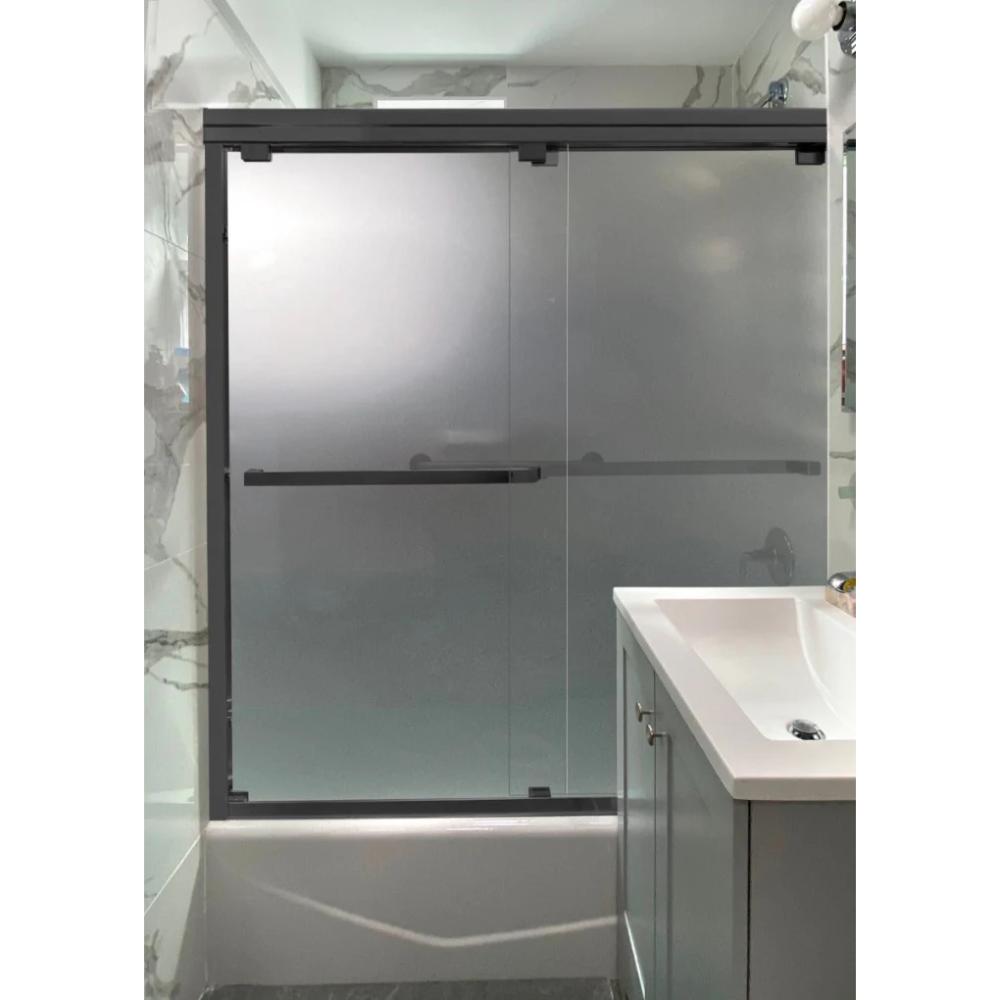 The ASD Cascade Shower Door – Bypass Sliding showcases frosted glass panels with a black frame, installed over a bathtub next to a white sink and vanity in a modern bathroom featuring marble-patterned walls.