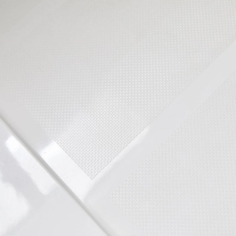 Close-up of the Bhavana Single Threshold Shower Base, white and textured, with a glossy transparent sheet partially covering it to highlight the contrast between matte and shiny surfaces.