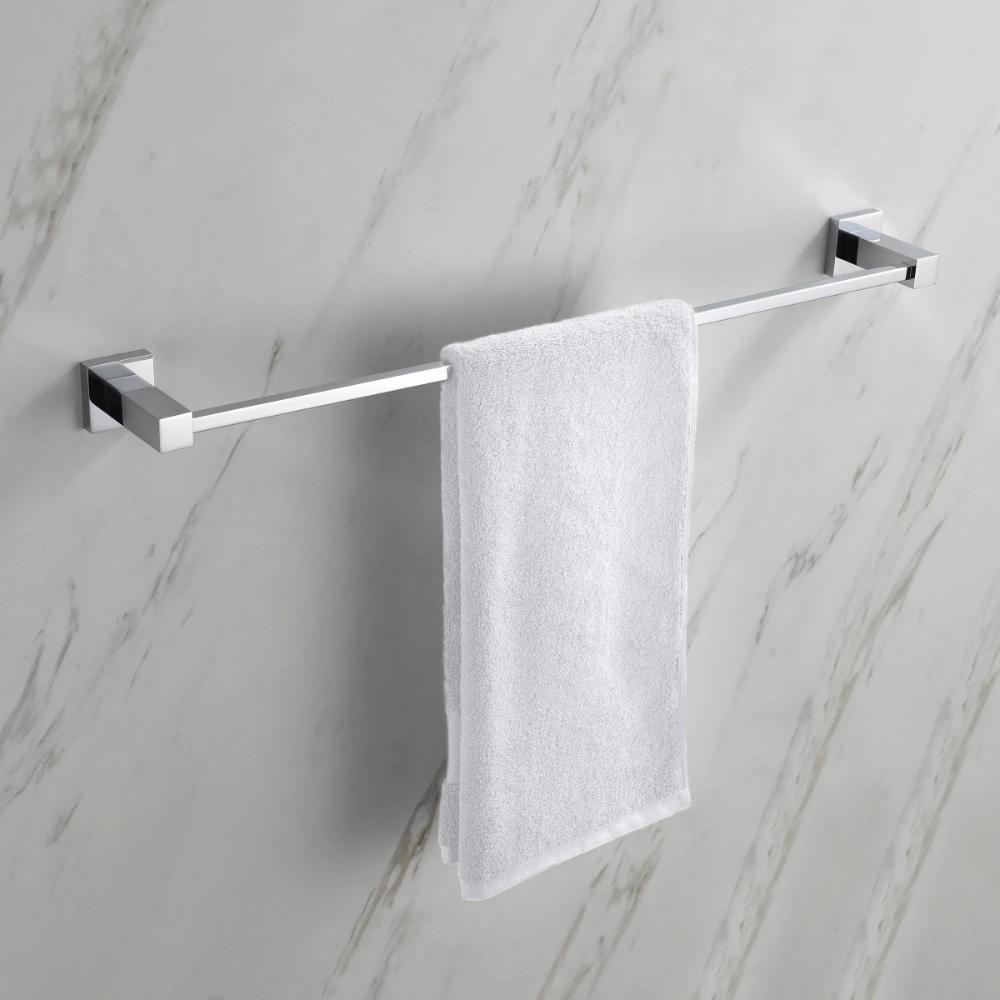 A white towel neatly hangs on the modern Quadra Bathroom Towel Bar, which is mounted on a light-colored marble wall.