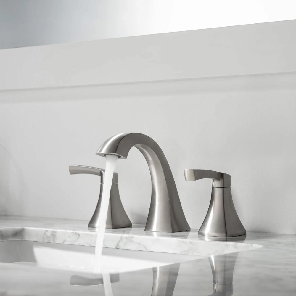 A Vermont 8 Inch Widespread Bathroom Sink Faucet in brushed nickel with two handles is installed on a white marble countertop, with water flowing from the spout into the sink.