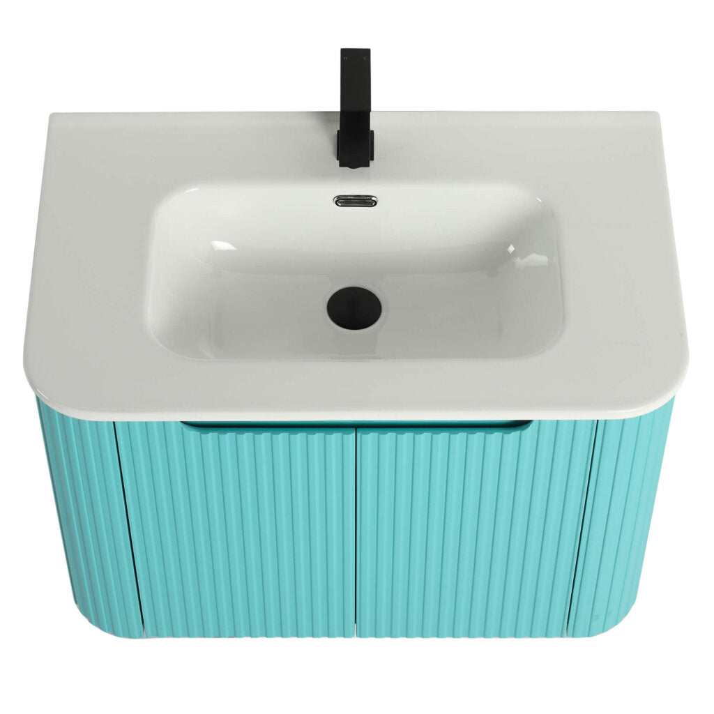 A top-down view of the Caskvalley 30 Inch Wall Mounted Bathroom Vanity With Sink highlights its modern aesthetic with a glossy white basin, sleek black faucet, and turquoise cabinet featuring a vertical ribbed texture. The vanity has two doors and is set against a plain white background.