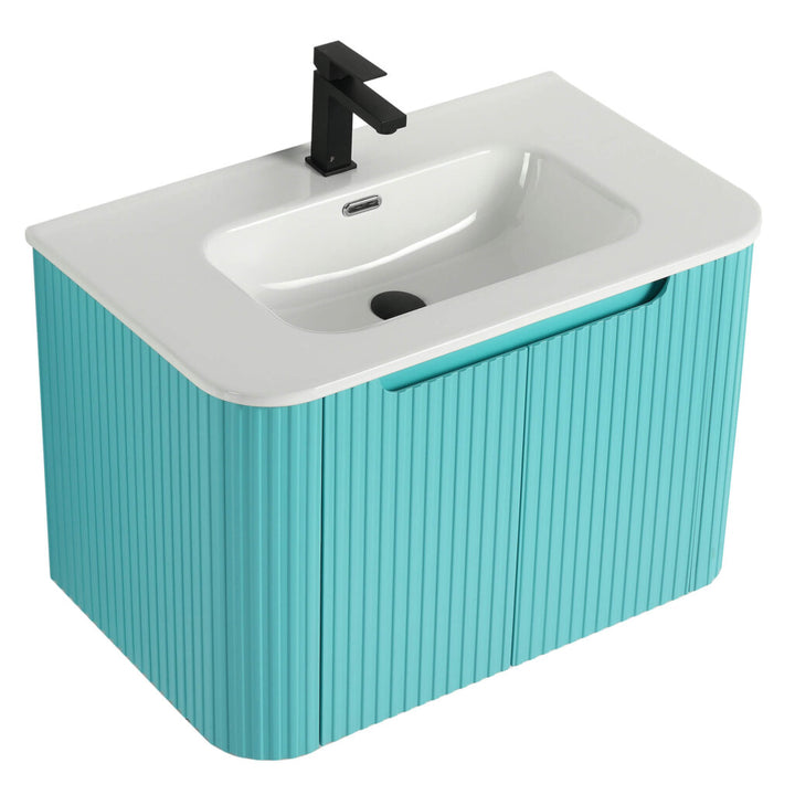 The Caskvalley 30 Wall Mounted Bathroom Vanity With Sink features a modern glossy white basin on a turquoise ribbed cabinet, complemented by a matte black faucet and drain stopper, capturing minimalist contemporary design.