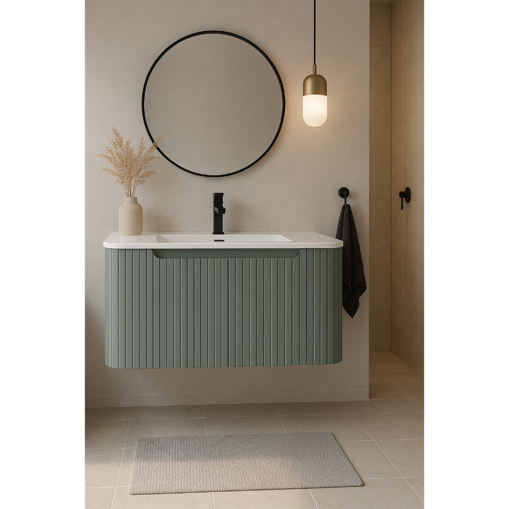 The contemporary bathroom showcases a Caskvalley 30 Inch Wall Mounted Bathroom Vanity with Sink, finished in green and topped with a sleek white sink. A round mirror adds elegance above, accompanied by a vase of dried grasses. A small pendant light enhances the setting, while a gray rug graces the tiled floor.