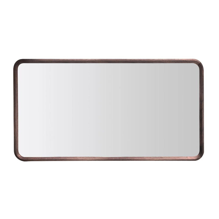 The Vela Mirrors wall mirror features a dark brown wooden frame with rounded corners, reflecting a plain white background.