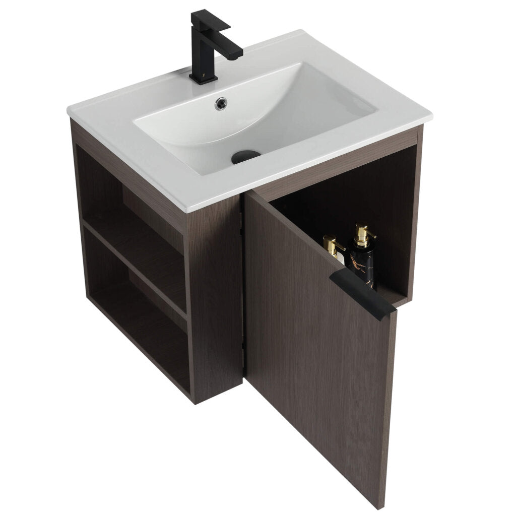 The Elmridge 24 Wall Mounted Bathroom Vanity With Sink features a modern design including a square white basin and sleek black faucet, complemented by a dark brown wooden cabinet with side shelving, an open door, and two visible bottles for easy storage.