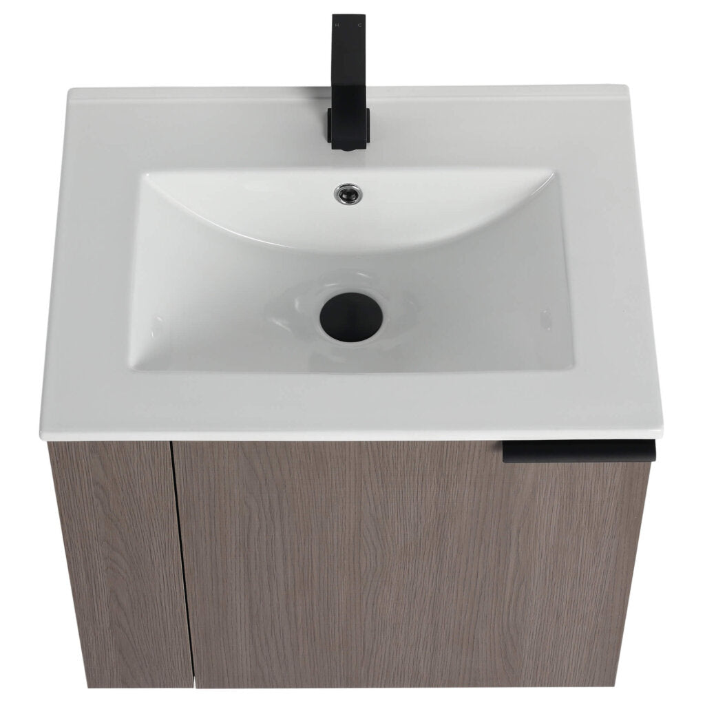 The Elmridge 24 Inch Wall Mounted Bathroom Vanity features a modern white rectangular basin with a black faucet, mounted on a wood-textured cabinet with a black handle, offering contemporary elegance through its minimalistic design.