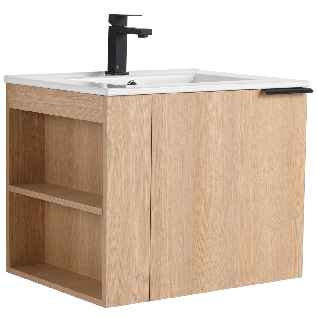 The Elmridge 24 Wall Mounted Bathroom Vanity With Sink features a modern wooden design in a light oak finish, a rectangular white sink with a sleek black faucet, plus an open left shelf and right cabinet with black handle.