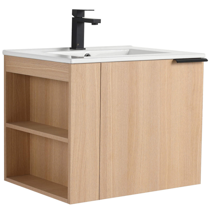 The Elmridge 24 Wall Mounted Bathroom Vanity With Sink features a modern wooden design in a light oak finish, a rectangular white sink with a sleek black faucet, plus an open left shelf and right cabinet with black handle.
