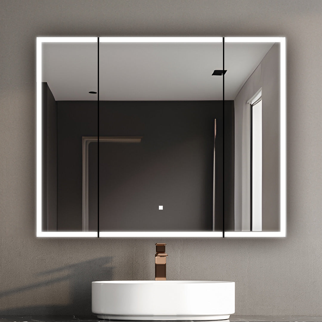 A modern bathroom features a circular white sink, bronze faucet, and the Edge Royal 40 Inch LED Lighted Mirror Medicine Cabinet on a gray wall, reflecting a minimalist room with a window.