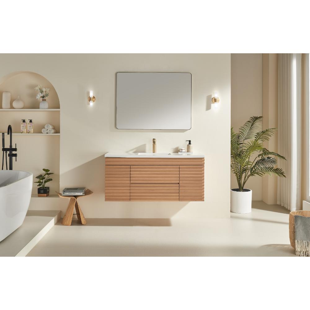 Minimalist bathroom featuring the Linea 48 Inch Wall Mounted Bathroom Vanity, a rectangular mirror, modern lighting, potted plant, decorative shelves, and a white freestanding tub in a bright, neutral-toned space.