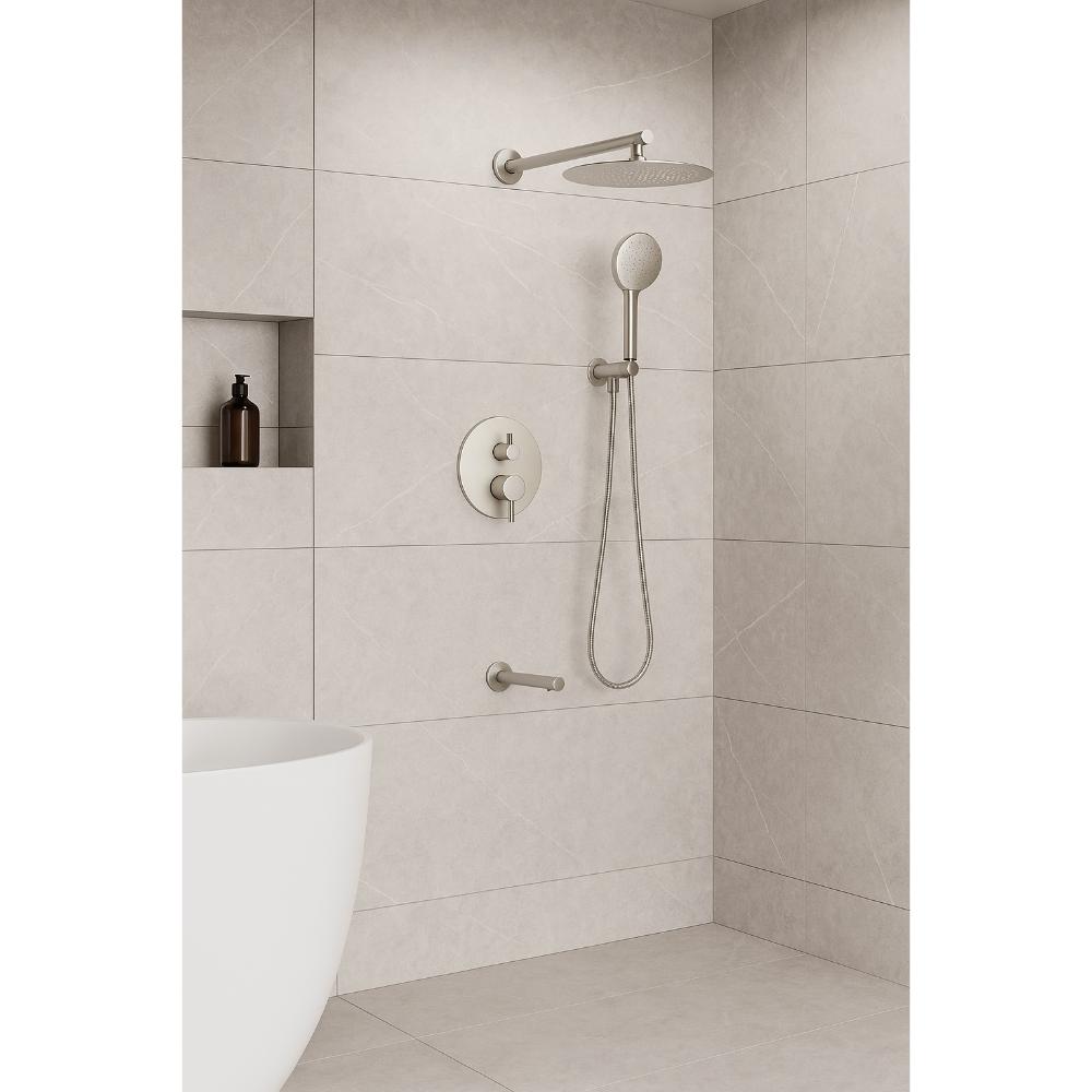 A modern bathroom with beige tiled walls showcases the Halo Pressure Balanced Wall Mount Shower System, featuring a round rainfall showerhead, handheld shower, built-in shelf with a bottle, grab bar, and white bathtub.