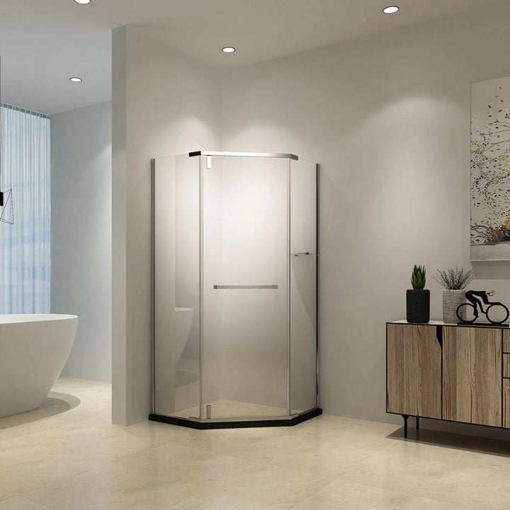 A modern bathroom features the Maggie Neo Angle Hinged Shower Door in a frameless glass corner, a freestanding tub, light walls and floor, recessed ceiling lights, and a wooden cabinet with decor.