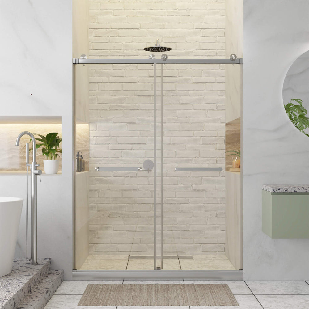 Modern bathroom featuring the Shower Door Double Sliding Frameless on a glass tub, white brick wall, overhead shower, built-in shelves with potted plants, white bathtub, circular mirror above green vanity, and a beige mat on the floor.
