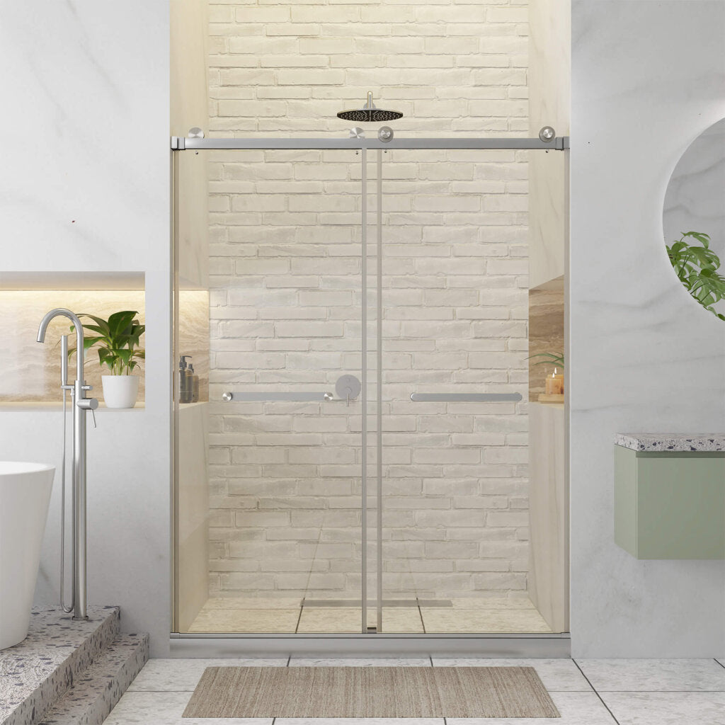 Modern bathroom featuring the Shower Door Double Sliding Frameless on a glass tub, white brick wall, overhead shower, built-in shelves with potted plants, white bathtub, circular mirror above green vanity, and a beige mat on the floor.