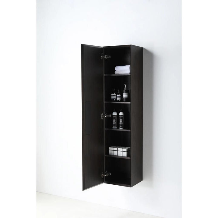 The Cartisan Design Side Cabinet, tall and dark wooden with one open door, displays four shelves holding towels, bottles, jars, and small boxes against a plain white background.