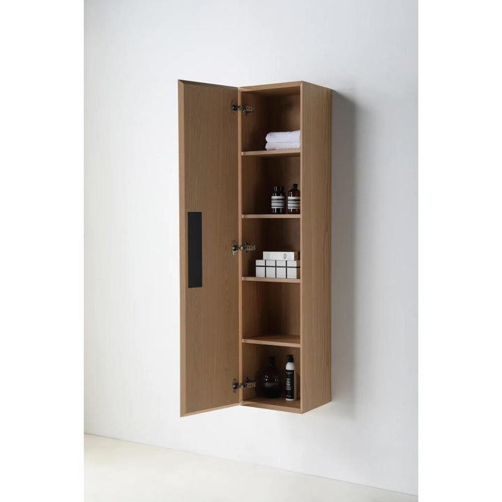 The Cartisan Design Side Cabinet is a wooden, wall-mounted unit with one door open, revealing four shelves stocked with folded towels, bottles, and small boxes against a plain white wall.